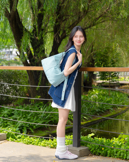 SIGNATURE POCKET HOBO BAG IN LIGHT WASH DENIM